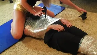 Госпожа в шортах сидит жопой на лице раба, связанного пищевой пленкой